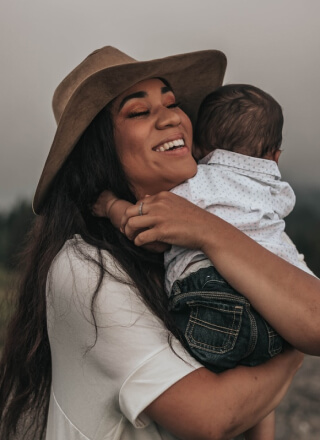 day-care-head-of-school A mother hugging her baby. She looks blissful.