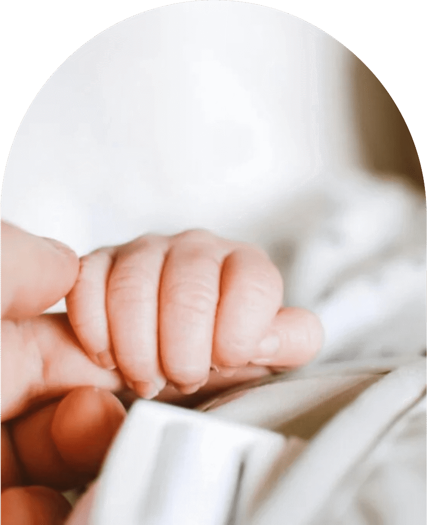 about-hero-image-min-2 Baby holding parent's finger.